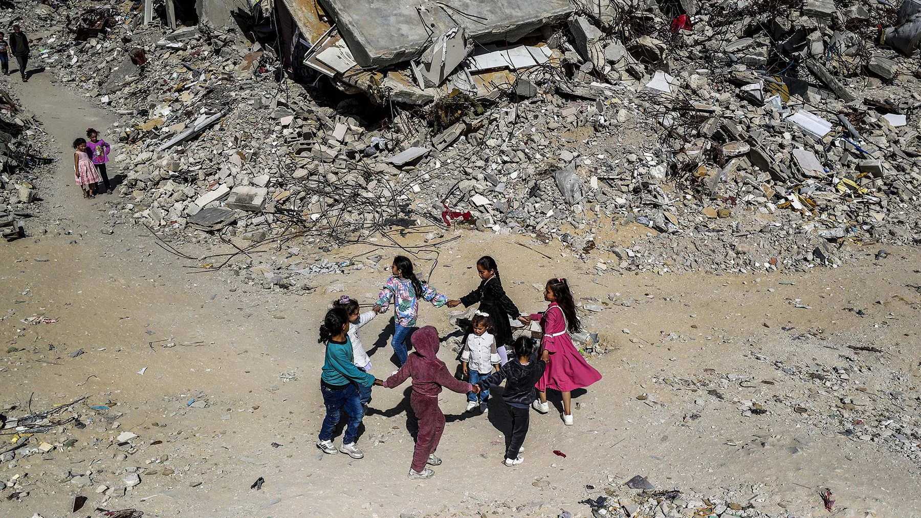 Children playing amid the rubble